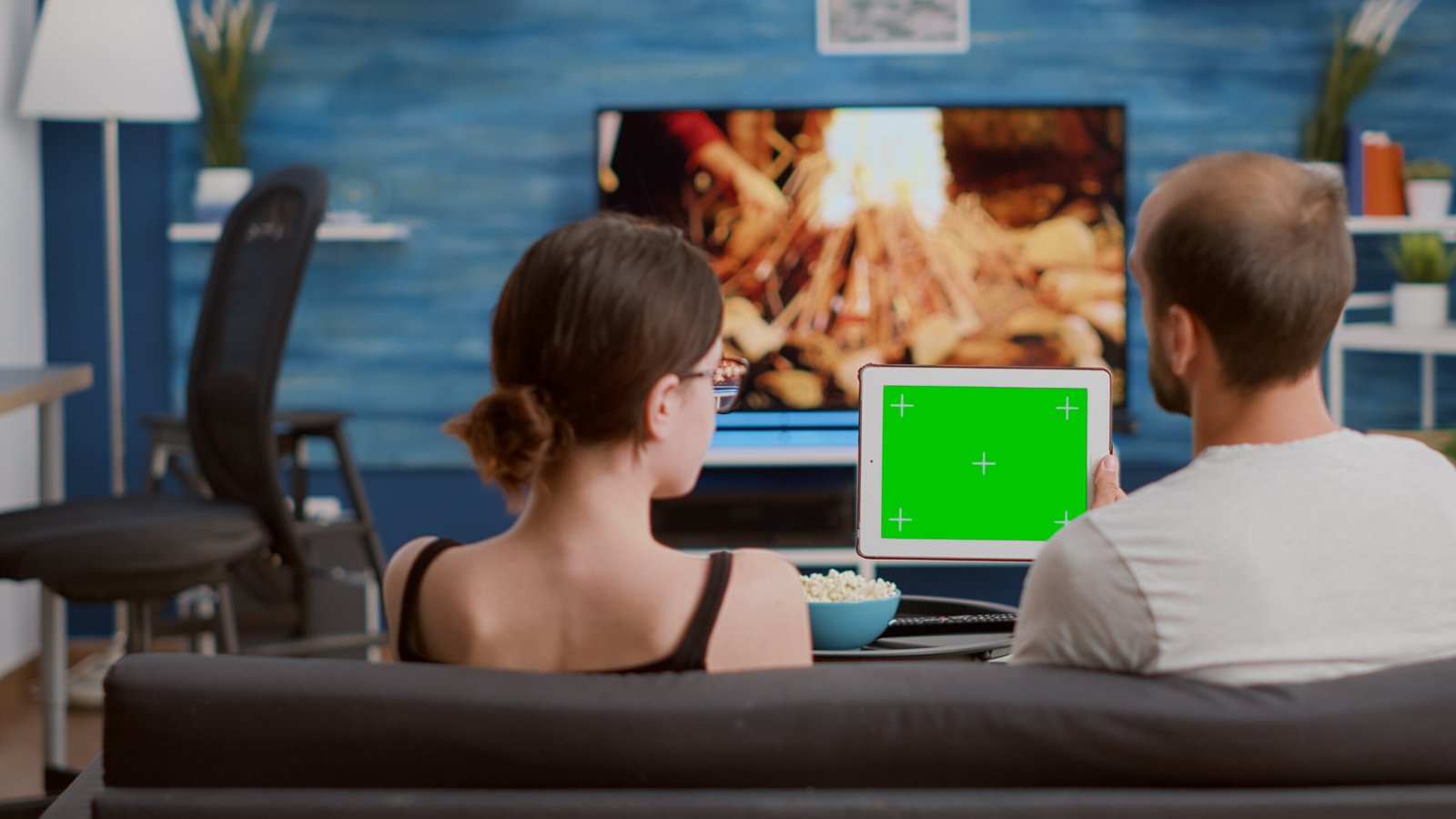 couple relaxing sofa looking social media video content using digital tablet with green screen living room man woman enjoying free time watching influencer vlog chroma key device scaled