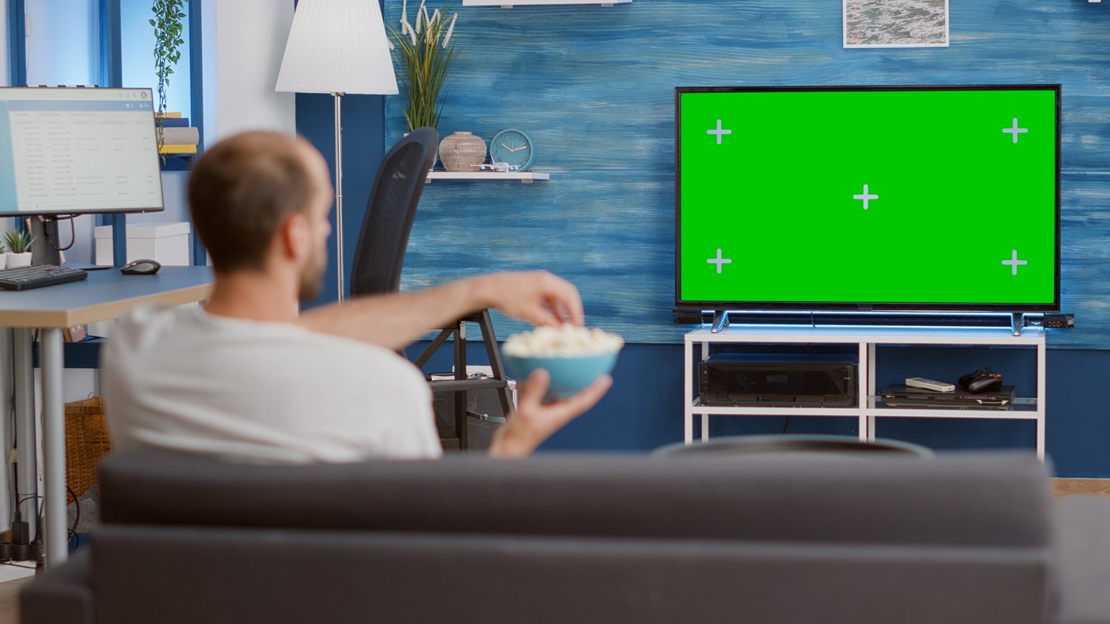 IPTV Streaming: The Complete Beginner’s Guide 2026 3 man relaxing couch looking green screen tv watching movie while eating popcorn modern living room person having good time sitting sofa looking television with chroma key display scaled